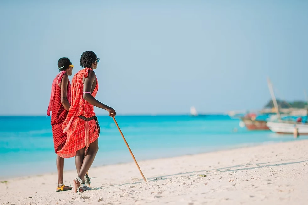 Maasai people visiting Zanzibar, showcasing traditional attire and cultural exchange experiences for travelers.