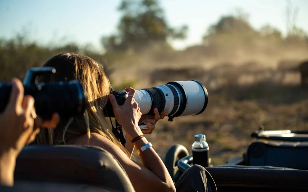 Photographers capturing wildlife on a private game drive in Tanzania’s national parks, including big cats and savannah scenery.