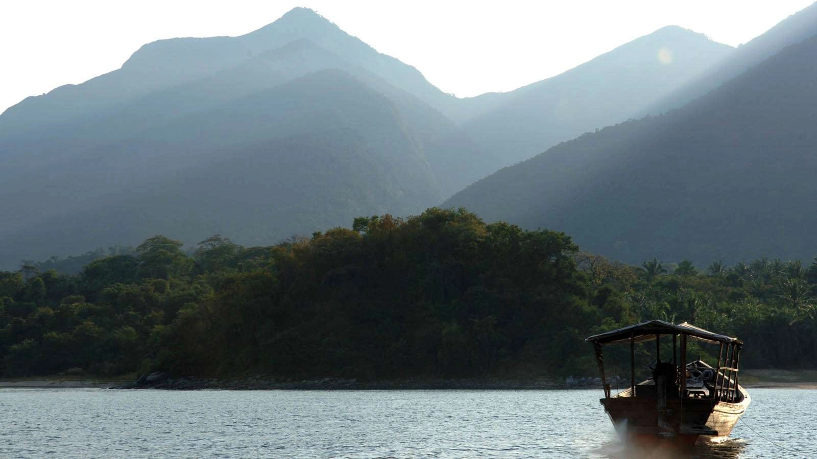 Local fishermen paddling traditional wooden boats on Lake Tanganyika near Mahale Mountains National Park, Tanzania.