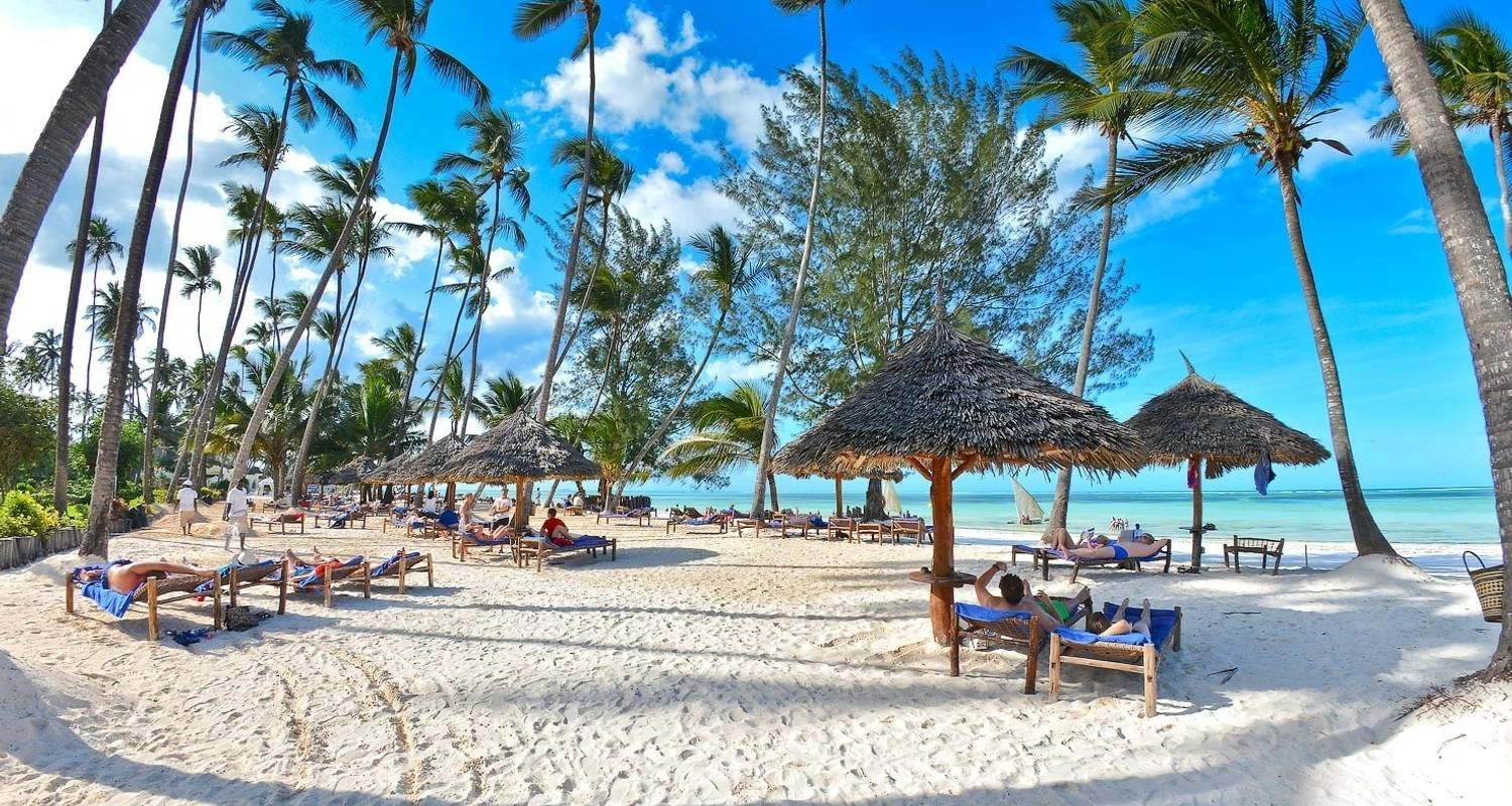 Tanzania safari and Zanzibar beach holiday: travelers watching wildlife in Serengeti National Park with Zanzibar beach in the background